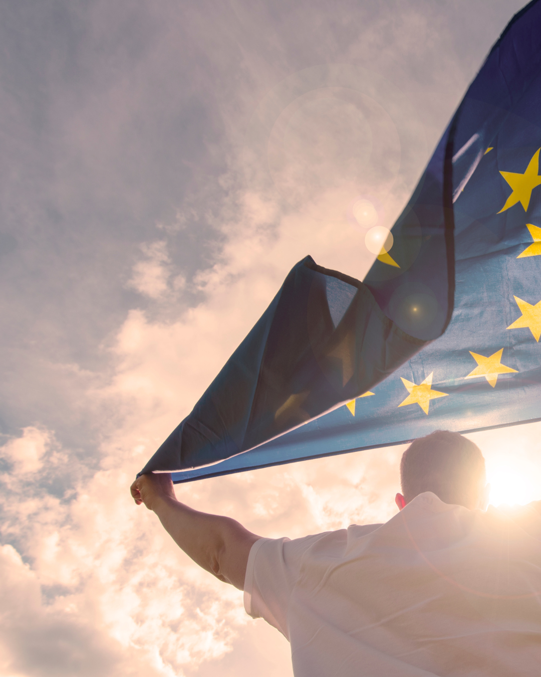 A man holds an EU flag.