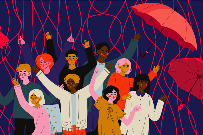 Group of diverse people surrounded by red umbrellas and red streamers.