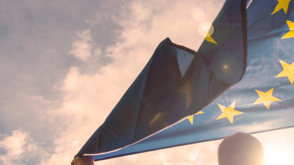 A man holds an EU flag.